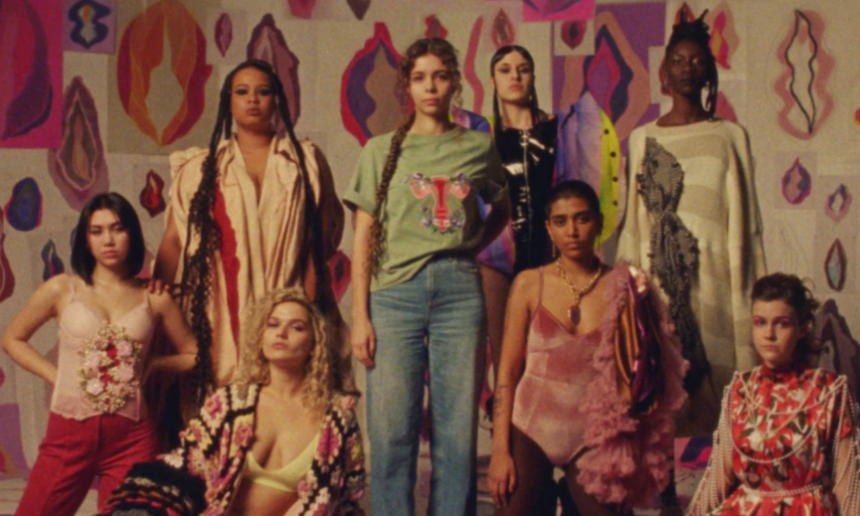 Women+ standing together with vulva illustration in the background